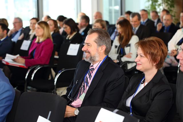 a group of people sitting at a table in front of a crowd