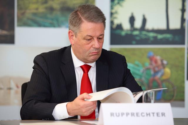 a man wearing a suit and tie reading a book