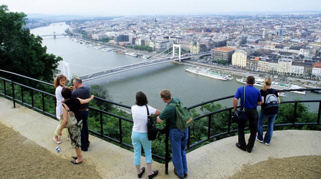 a group of people at a lookout over a city