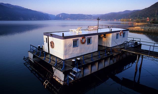 a boat is docked next to a body of water