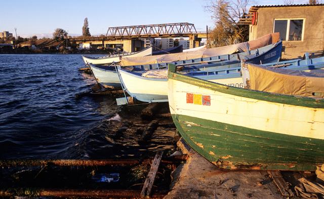 a boat is docked next to a body of water