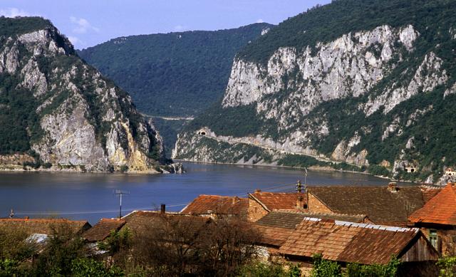 a body of water with a mountain in the background