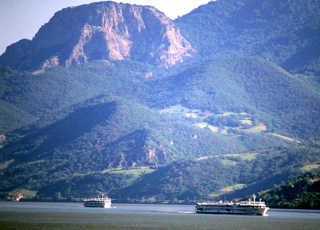 a large body of water with a mountain in the background