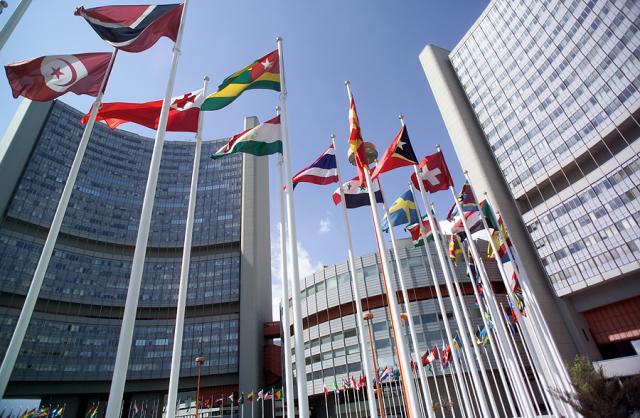 a tall building with flags