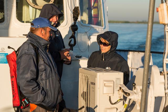 a couple of people that are standing in front of a boat