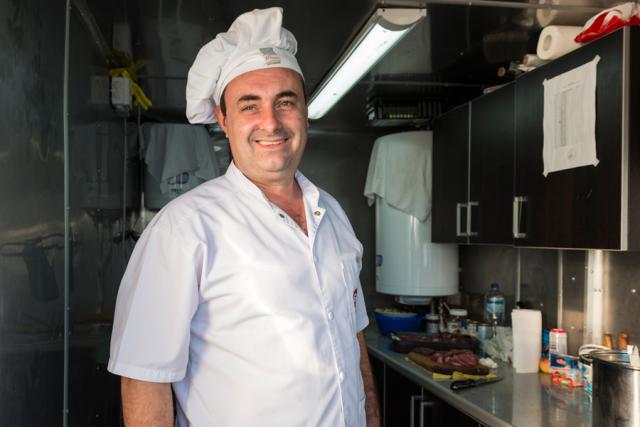 a man standing in a kitchen preparing food