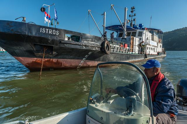 a boat is docked next to a body of water