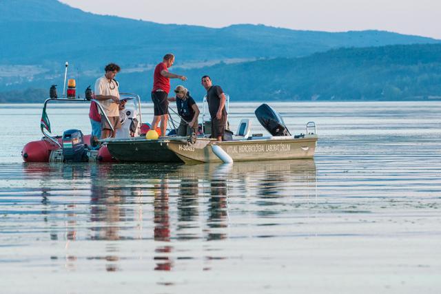 a group of people in a small boat in a body of water