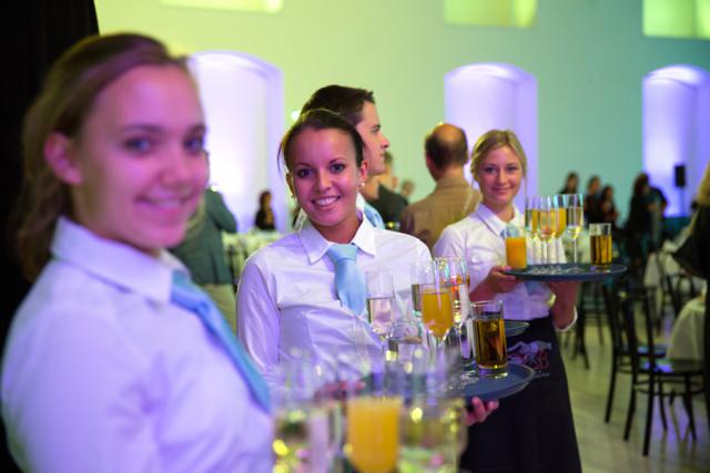 a group of people sitting at a table with wine glasses