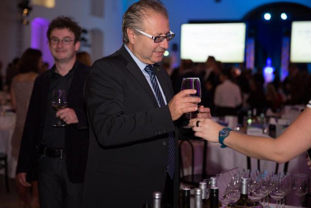 a man holding a glass of wine