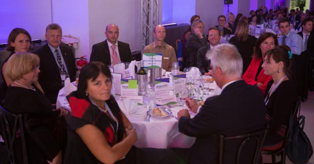 a group of people sitting at a table with wine glasses