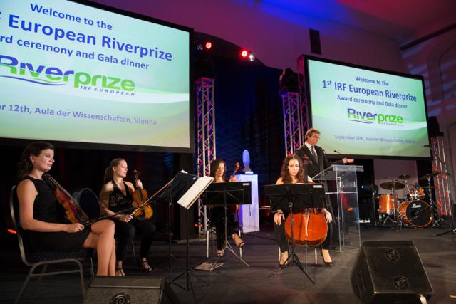 a group of people performing on stage in front of a store