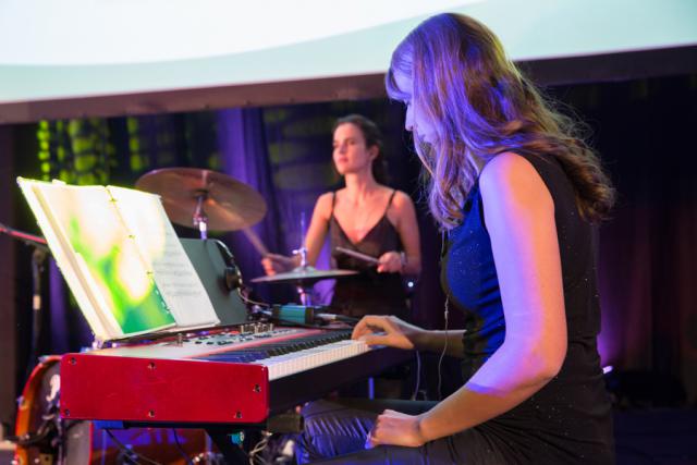 a woman standing in front of a piano