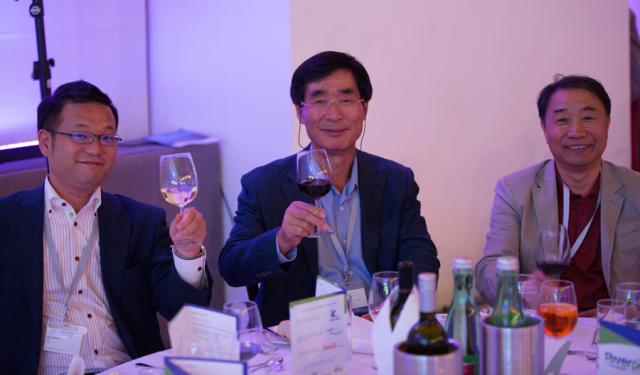 a group of people sitting at a table in a suit and tie