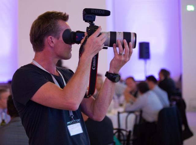 a man holding a camera in front of a mirror posing for the camera