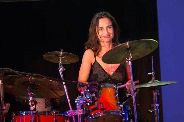 a woman standing in front of a stage