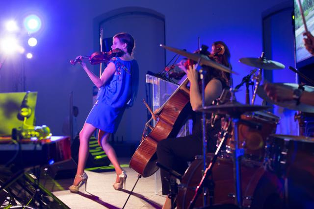 a person standing on a stage playing instruments