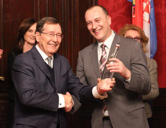 a group of people standing next to a man in a suit and tie