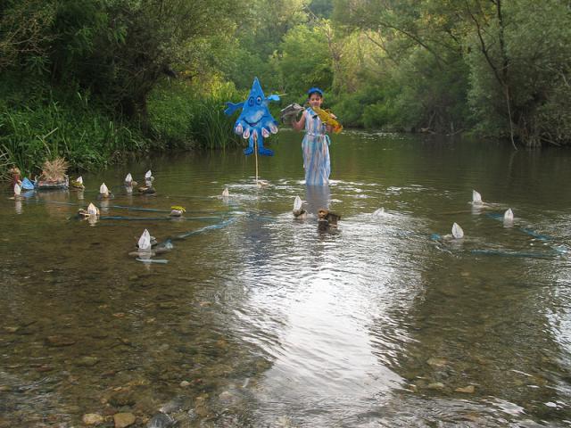 a person standing next to a body of water