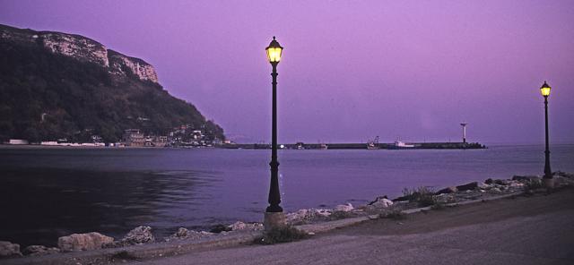 a large body of water with a mountain in the background