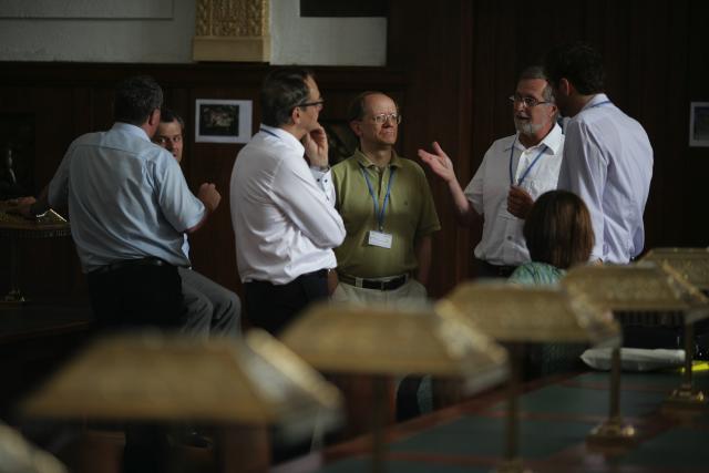 a group of people standing around a table