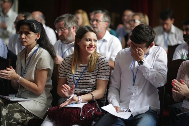 a group of people sitting in front of a crowd