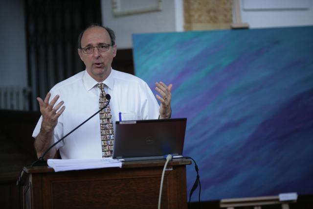 a man standing in front of a laptop