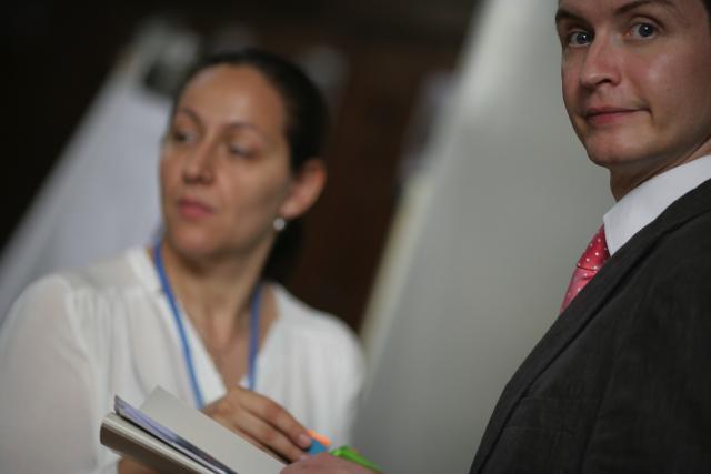 a man and a woman looking at the camera