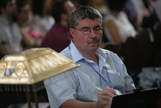 a man sitting at a table using a laptop