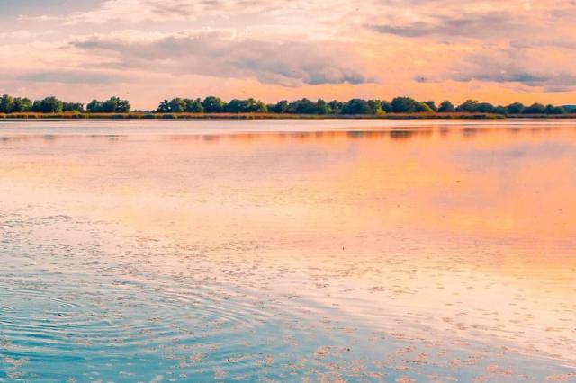 Sunset on the water in Romania