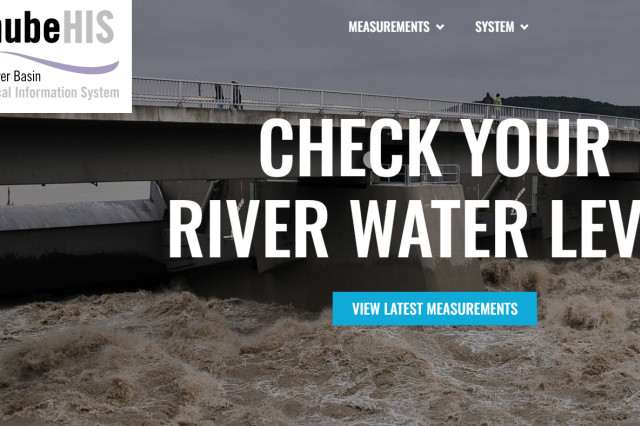 Image of a river at a hydropower plant. On the left handside a logo of the DanubeHIS portal, in the center a text  that reads: check your water level. A blue box in the centrer below the text reads view latest measurements.