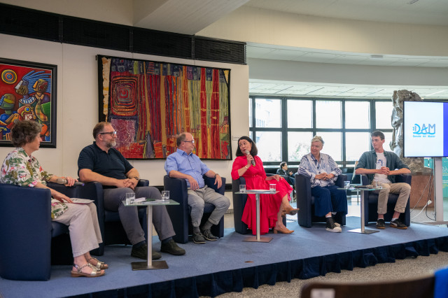 6 persons sitting on a panel