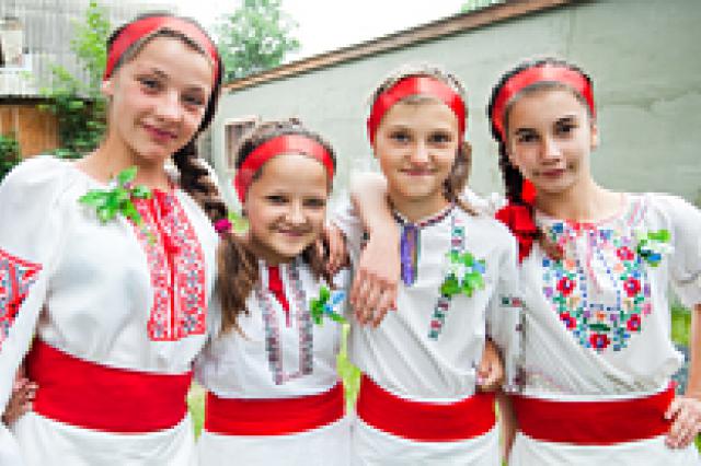 Young girls in traditional clothing posing for picture