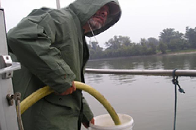 a man standing next to a body of water