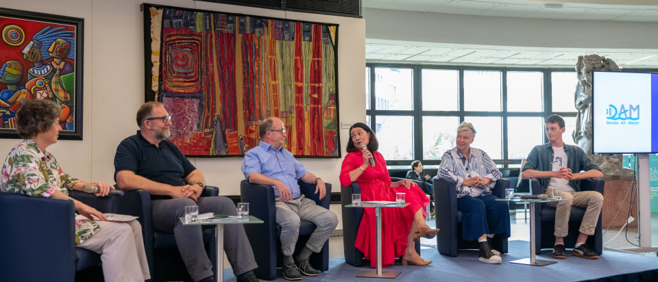 6 persons sitting on a panel