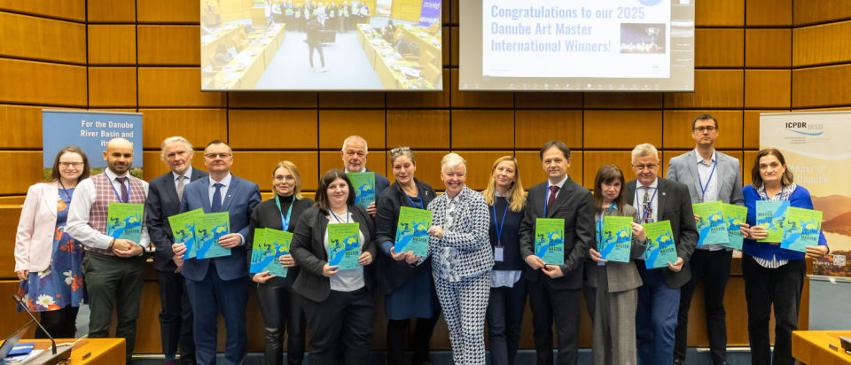 Group of people stand and hold Danube Art Master 2025 certificates. 
